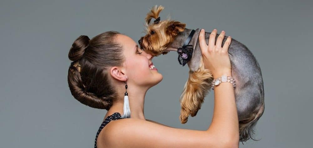 woman with allergies holding yorkie